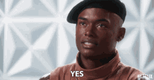 a man wearing a beret and a turtleneck sweater says yes