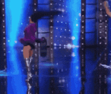 a blurred image of a person in a purple dress