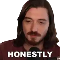 a man with long hair and a beard has the word honestly on his shirt
