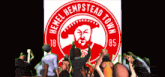 a group of people are standing in front of a logo for hemel hempstead town
