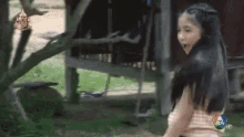 a little girl is standing in front of a tree and a sign that says 7 hd