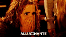 a woman is covering her face with her hands and the word allucinante is above her head