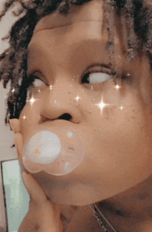a person with a bubble in their mouth making a face