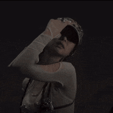 a black and white photo of a woman wearing a hello kitty belt and a hello kitty hat