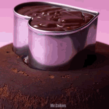 a chocolate cake with a heart shaped cutter on top of it