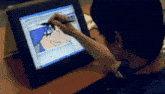 a person is drawing a cartoon on a screen