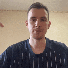 a man with a beard wearing a striped shirt