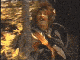 a man with red hair and a beard is standing in the woods with his mouth open