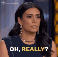 a woman wearing dior earrings and a necklace says oh really