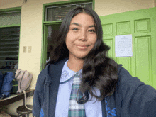 a girl in a school uniform takes a selfie