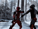 a man in a deadpool costume fighting another man in a snowy forest