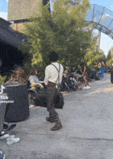 a woman in a wheelchair is sitting next to a man in suspenders