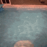 a man in a black bikini is floating in a pool