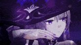 a girl with purple nails wearing a black hat