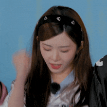 a young woman wearing a headband with hearts on it