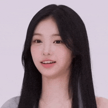 a close up of a woman 's face with long black hair .