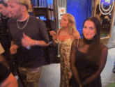 a group of people are standing in a room with a sign that says i love you on it