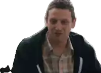 a man wearing a plaid shirt and a black hoodie is smiling