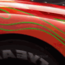 a close up of a red car with green lines painted on it