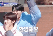 a boy in a blue jacket stands next to another boy in a pink shirt with boys planet written on it