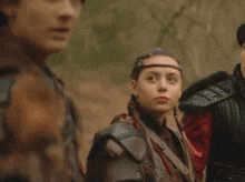 a man and a woman are standing next to each other and the woman is wearing a headband