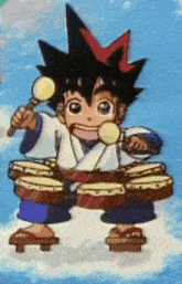 a boy in a kimono is playing drums and holding a microphone