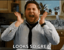 a man in a tie is making a funny face and says looks so great .
