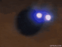 a close up of a person 's eye with the website gifrun.com written below it