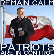 a man holding a cup of coffee stands in front of a polish flag with the words " remain calm patriots are in control "
