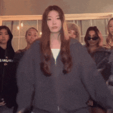 a woman wearing a grey sweatshirt with the word fearland on it