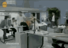 a group of people are sitting at desks in an office with the words xnovelaira on the bottom