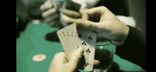 a close up of a person holding a pair of cards