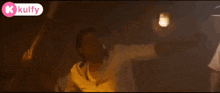 a man in a police uniform is standing in a dark room with a flashlight on his head .