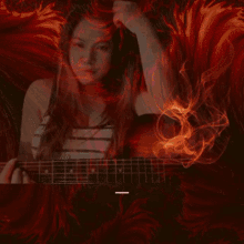 a woman is playing a guitar in front of a red background