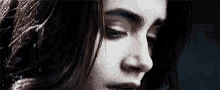 a close up of a woman 's face with a blurred background .