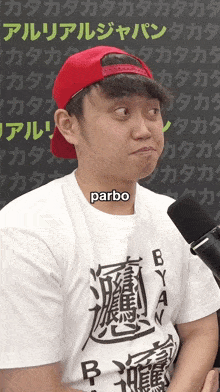 a man wearing a red hat and a white shirt with the word parbo on the collar