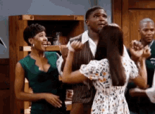 a man and a woman are dancing together in a room .