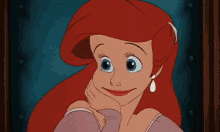 a cartoon of ariel from the little mermaid is smiling with her hand on her face .