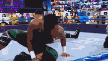 a pixelated image of two wrestlers in a wrestling ring with the letters w on it