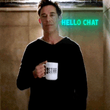 a man is holding a coffee mug with the word star on it