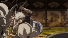 a man is holding a sword while another man is holding a sword in a room that says primera