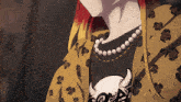 a woman with red hair is wearing a leopard print jacket and a necklace
