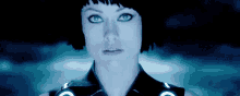 a close up of a woman 's face with a blue light behind her