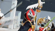 a person in a red helmet is holding a sword and a green sword .