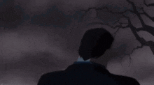 a man in a black suit is kicking a red rope in the air .