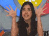 a woman with her hands in the air is wearing a shirt that says el