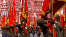 a group of soldiers marching in a parade holding flags that say ussr on them