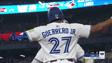 a baseball player named guerrero jr. has his arms outstretched