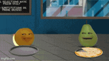 a pear and an orange are standing next to a pizza on a table