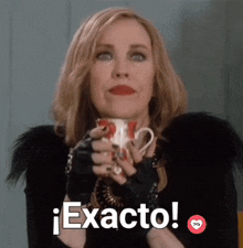 a woman is holding a cup of coffee and saying exacto in spanish